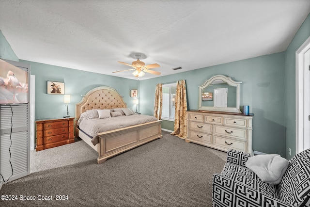 bedroom with ceiling fan, a textured ceiling, and carpet floors