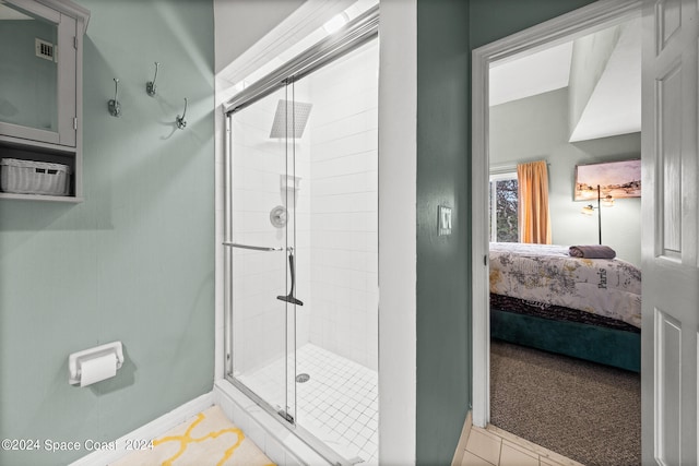 bathroom featuring an enclosed shower and tile patterned floors