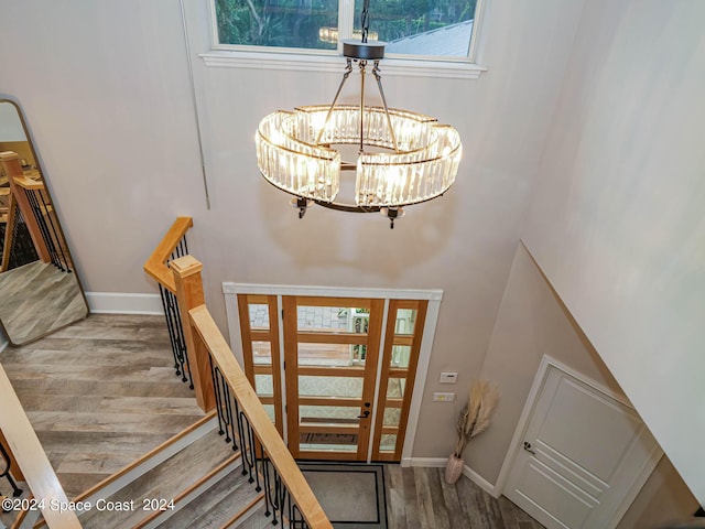 entrance foyer with hardwood / wood-style flooring and a chandelier