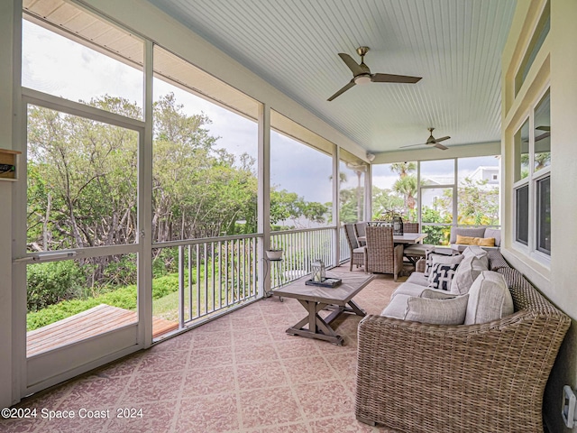 sunroom featuring ceiling fan