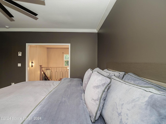 bedroom featuring ceiling fan and ornamental molding