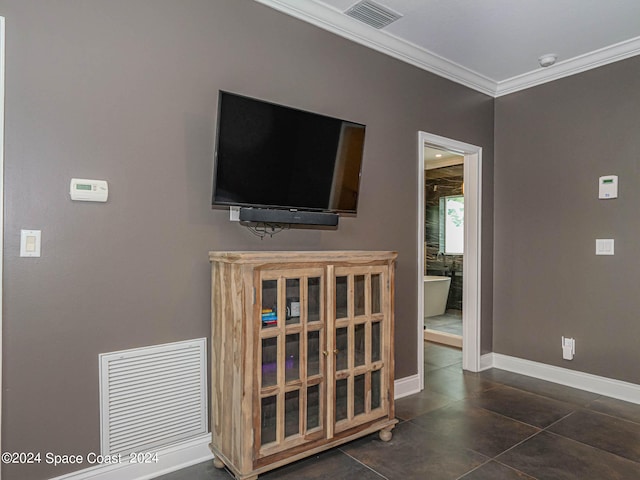 living room with crown molding and dark tile patterned floors