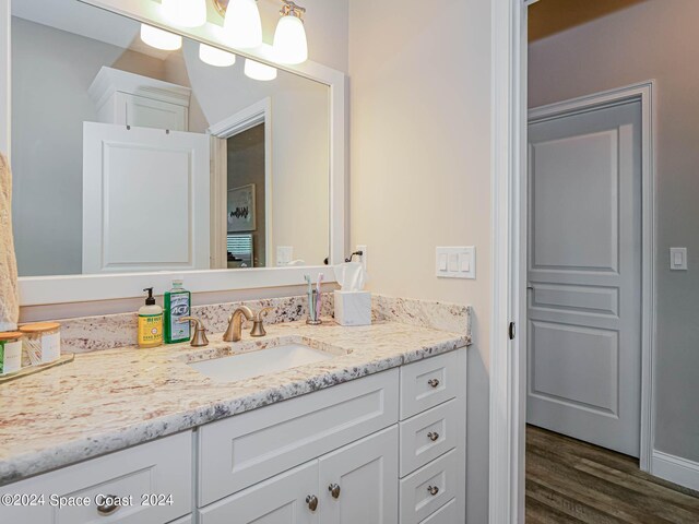 bathroom with vanity and wood-type flooring