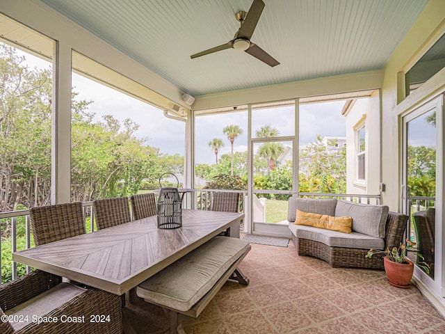 sunroom featuring ceiling fan and a wealth of natural light