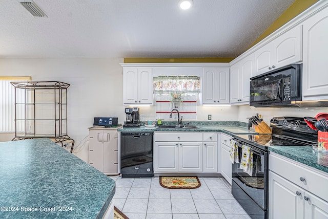 kitchen with black appliances, light tile patterned floors, white cabinetry, and sink