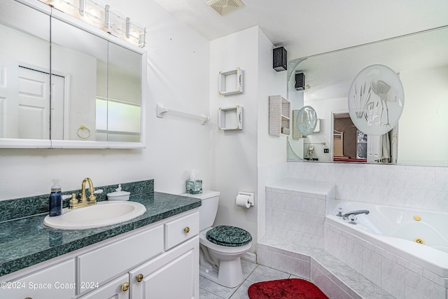 bathroom with tile patterned floors, toilet, a relaxing tiled tub, and vanity