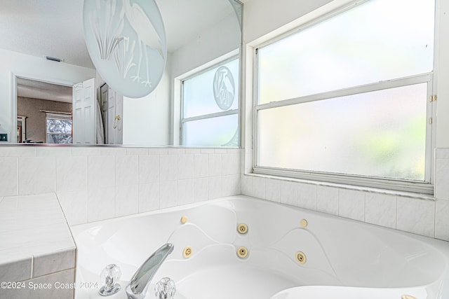 bathroom featuring a relaxing tiled tub