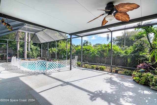 view of swimming pool featuring a lanai, ceiling fan, and a patio area