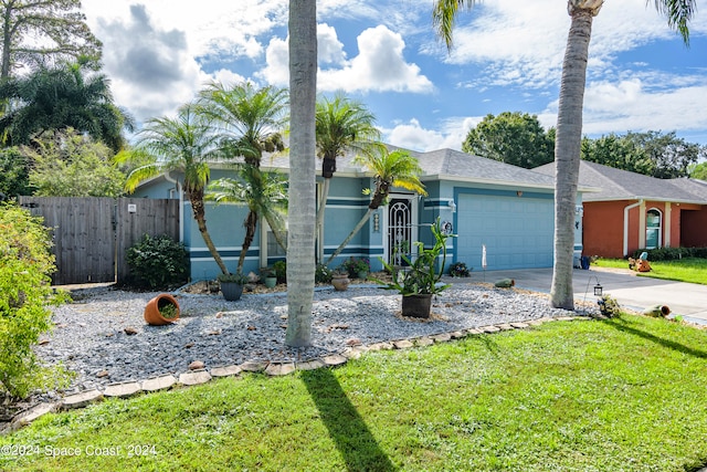 view of front of home featuring a garage and a front yard