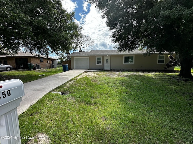 single story home featuring a garage and a front yard