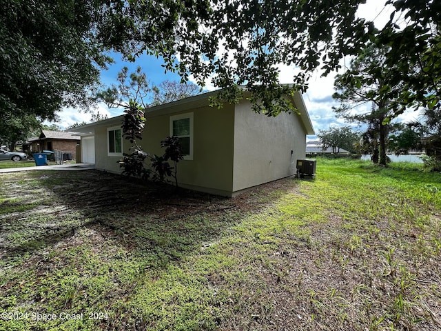 view of property exterior featuring cooling unit and a lawn