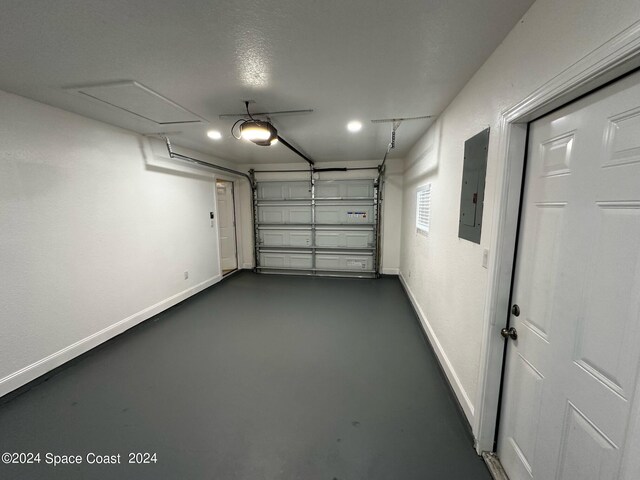 garage featuring a garage door opener and electric panel