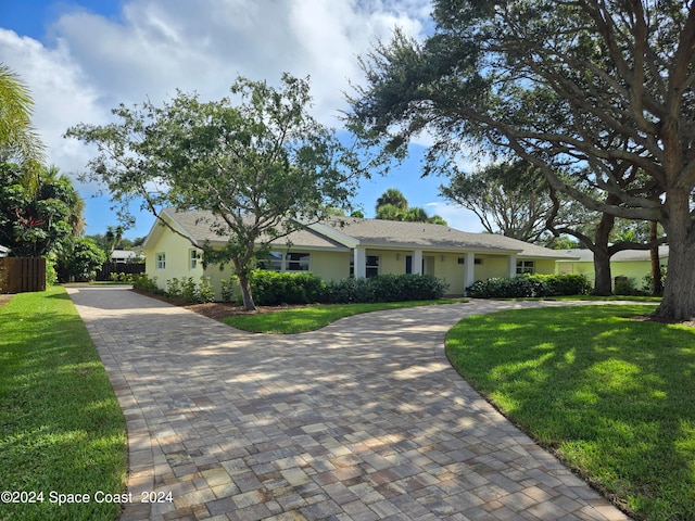 ranch-style home with a front lawn