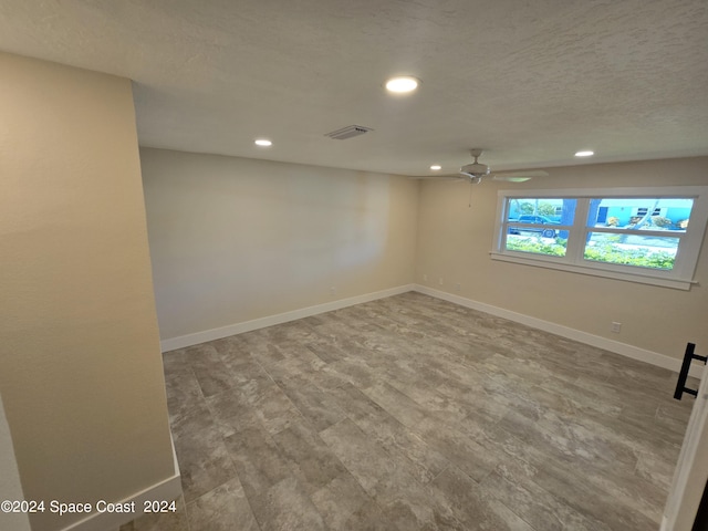 unfurnished room featuring a textured ceiling and ceiling fan