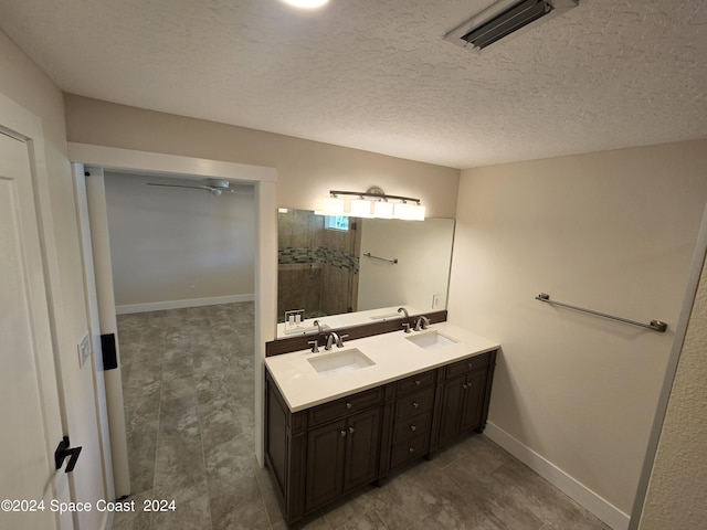 bathroom with vanity and a textured ceiling