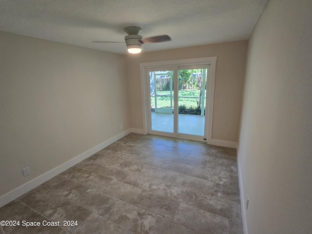 spare room with ceiling fan and a textured ceiling