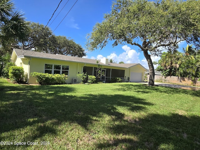 view of front of house with a garage and a front lawn