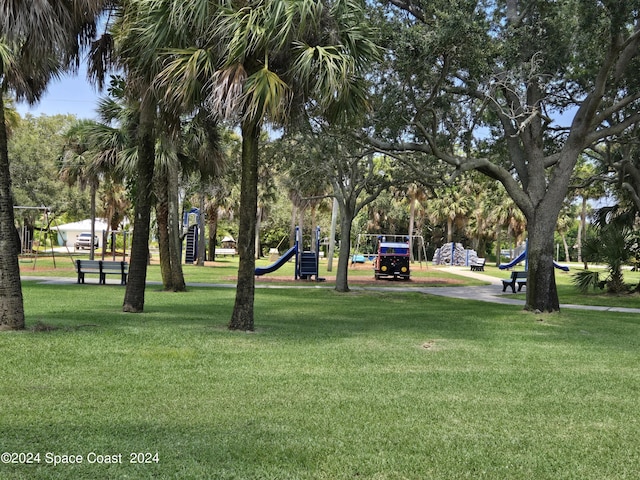 surrounding community with a lawn and a playground