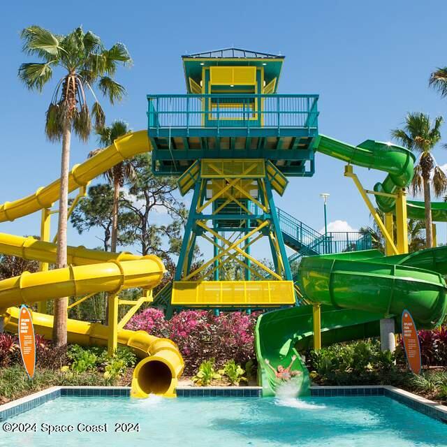 view of swimming pool featuring a water slide and a playground