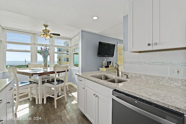 kitchen with backsplash, white cabinetry, stainless steel dishwasher, dark hardwood / wood-style floors, and sink