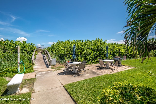 view of community featuring a patio and a yard