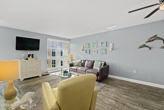 living room featuring ceiling fan, a textured ceiling, and light hardwood / wood-style flooring