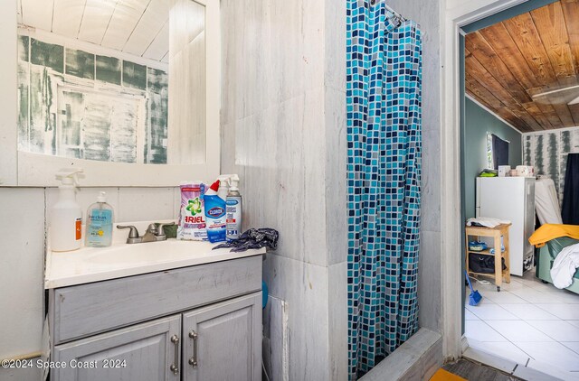 bathroom with wooden ceiling, vanity, a shower with shower curtain, and tile patterned floors