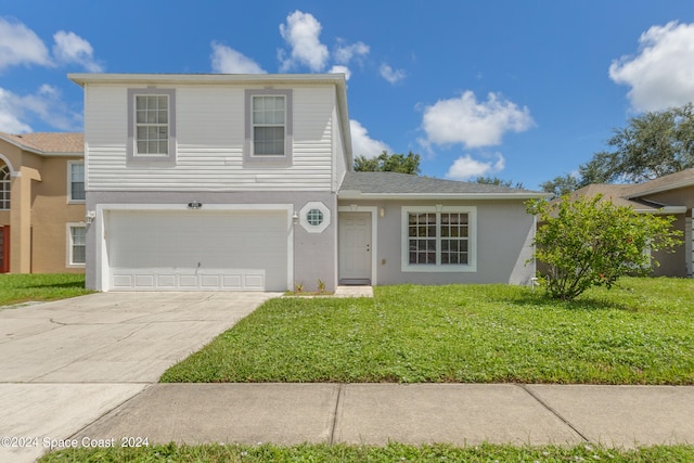 view of front property featuring a front lawn and a garage