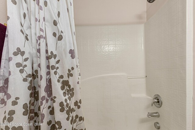 bathroom featuring shower / bathtub combination with curtain