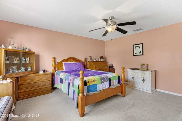 bedroom featuring ceiling fan and light carpet