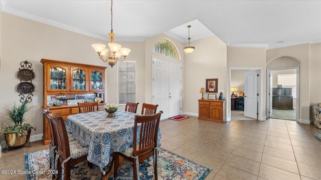 dining space featuring light tile patterned flooring, crown molding, and an inviting chandelier