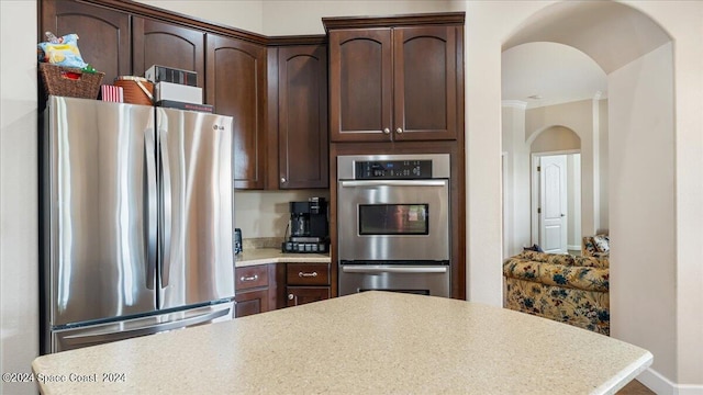 kitchen featuring dark brown cabinets and stainless steel appliances