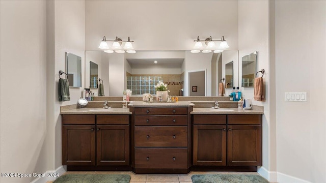 bathroom with dual bowl vanity and tile patterned flooring