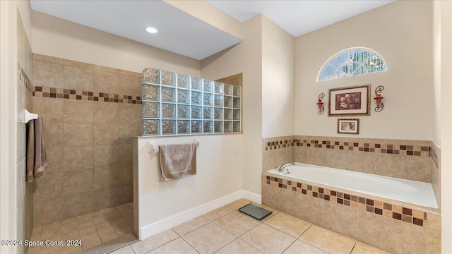 bathroom featuring tile patterned floors and tiled tub