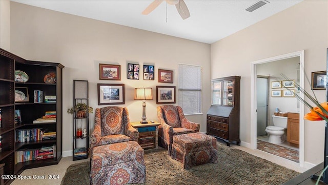 living area featuring light carpet and ceiling fan