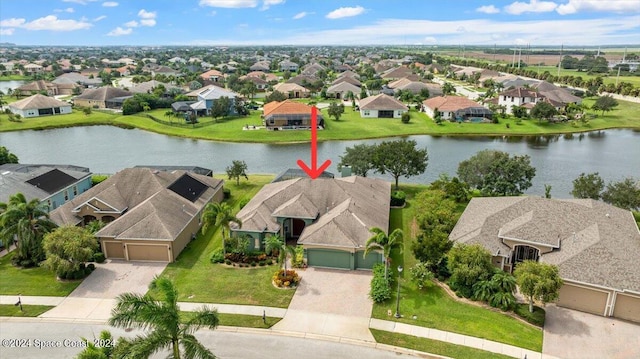 birds eye view of property featuring a water view