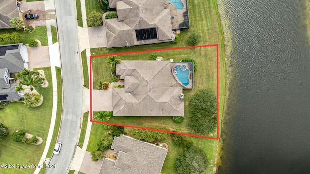 birds eye view of property with a water view