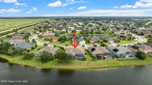 birds eye view of property with a water view