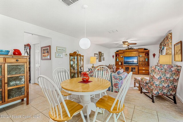 tiled dining room with ceiling fan