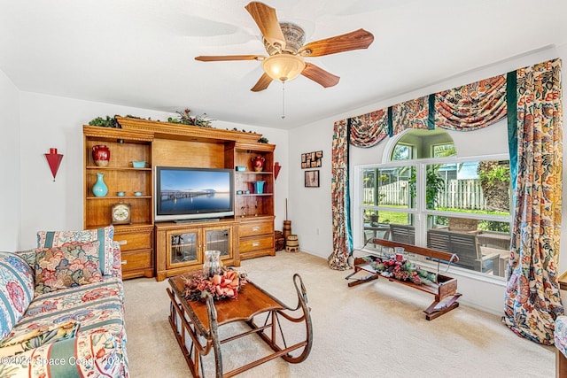 carpeted living room featuring ceiling fan