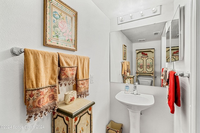 bathroom featuring lofted ceiling and toilet