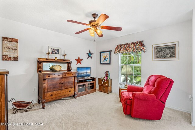 sitting room featuring ceiling fan and light carpet