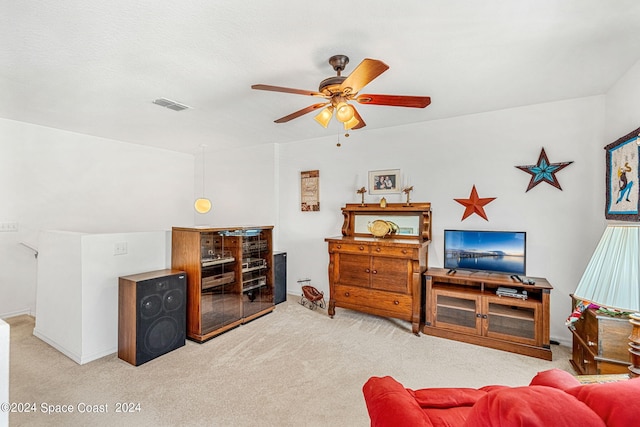 carpeted living room featuring ceiling fan