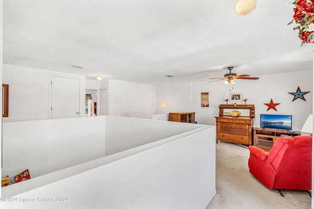 carpeted living room with ceiling fan