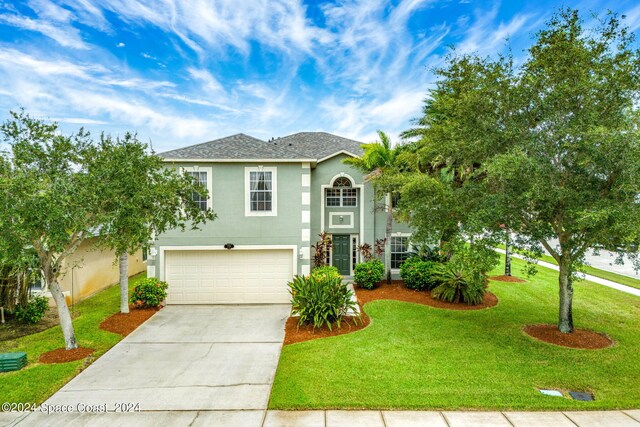 view of front of house with a garage and a front yard