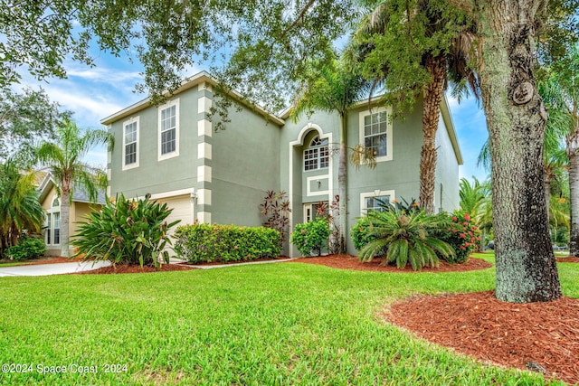 view of front facade featuring a front lawn and a garage