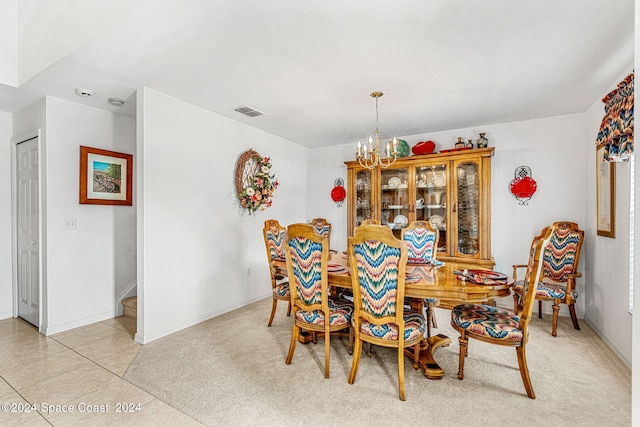 dining area with a notable chandelier and light tile patterned flooring