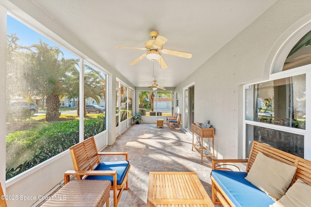 sunroom featuring ceiling fan and a healthy amount of sunlight