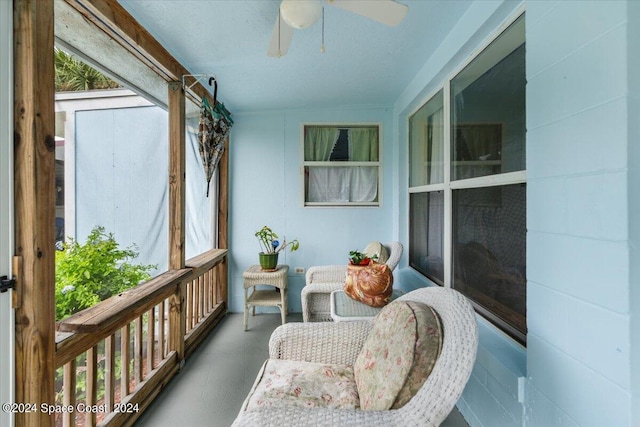 sunroom featuring a ceiling fan