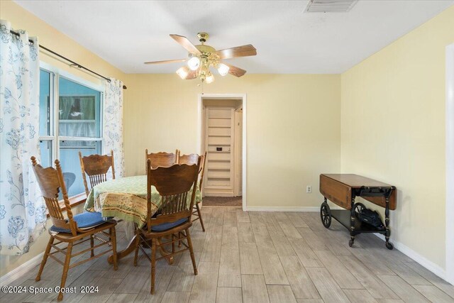 dining area with light hardwood / wood-style floors and ceiling fan